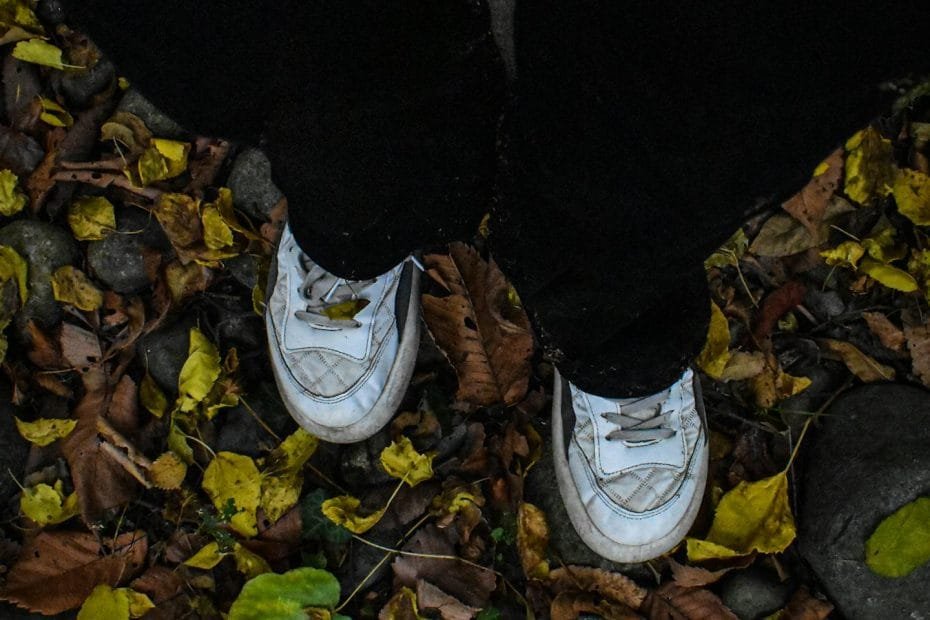 Man Wearing White Sneakers in a Forest