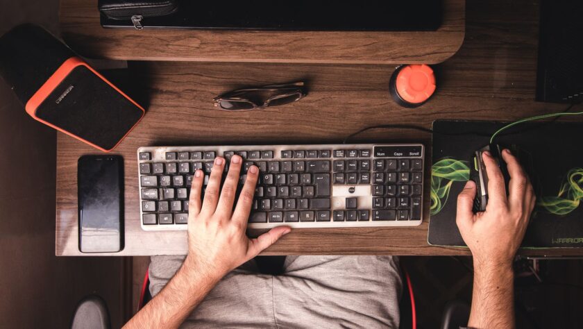 man using the keyboard and mouse for his computer