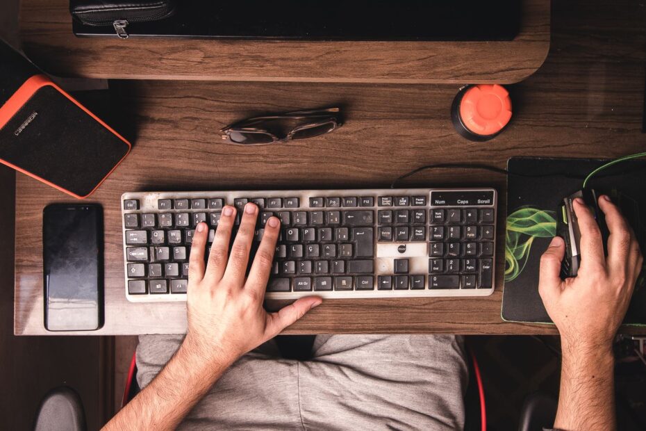 man using the keyboard and mouse for his computer