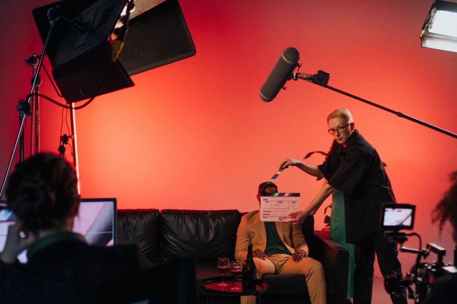 a person in black shirt holding a clapperboard during the filming